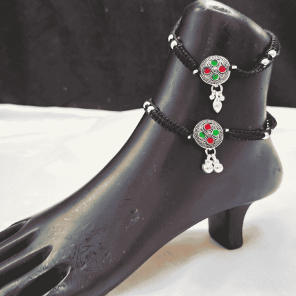Ethnic-style anklet set featuring red and green stonework with dangling charms